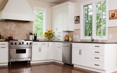 A kitchen with stainless steel appliances and white cabinets