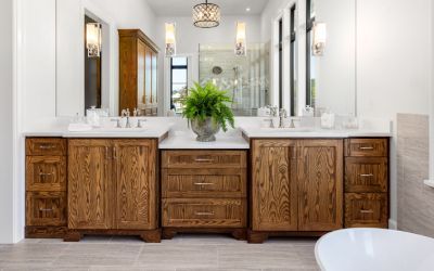 A bathroom with two sinks , two mirrors and a tub.