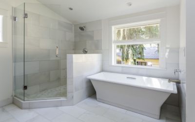 A bathroom with a tub , shower , and window.