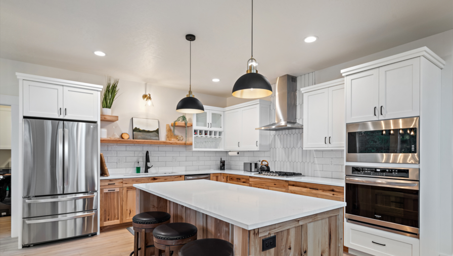 A living room with a couch, television, fireplace and stairs.