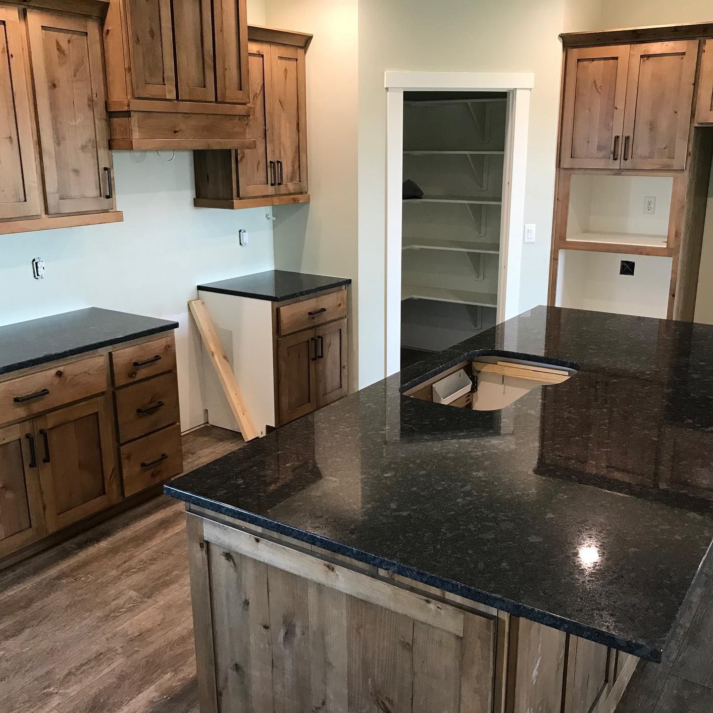 A kitchen with wooden cabinets and granite counter tops