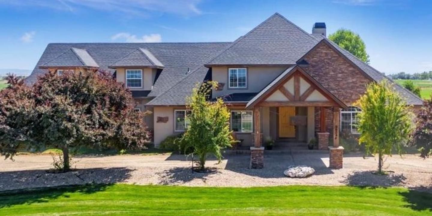 A large house with a lush green lawn in front of it