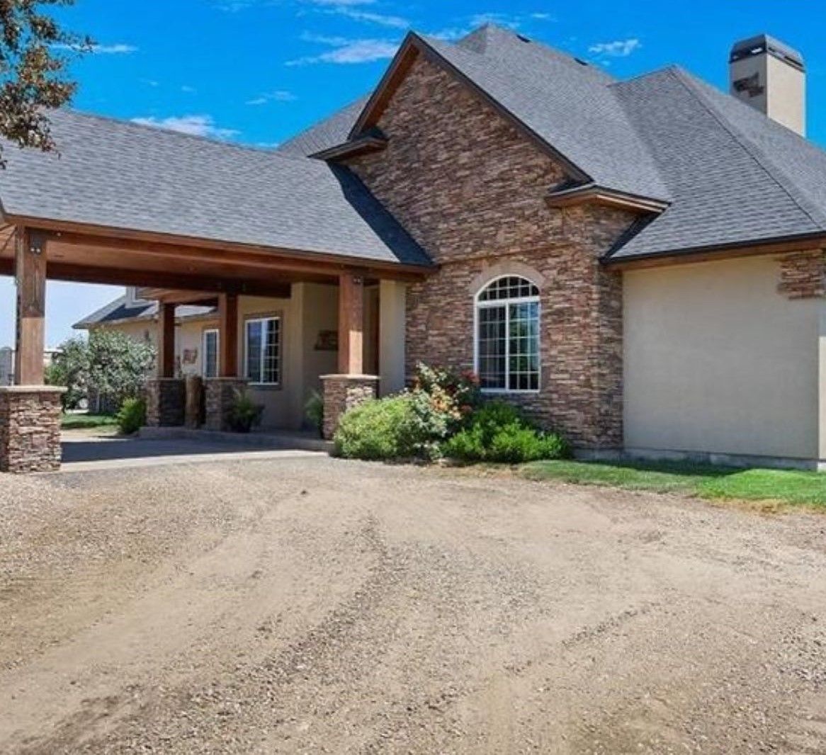 A large house with a driveway leading to it