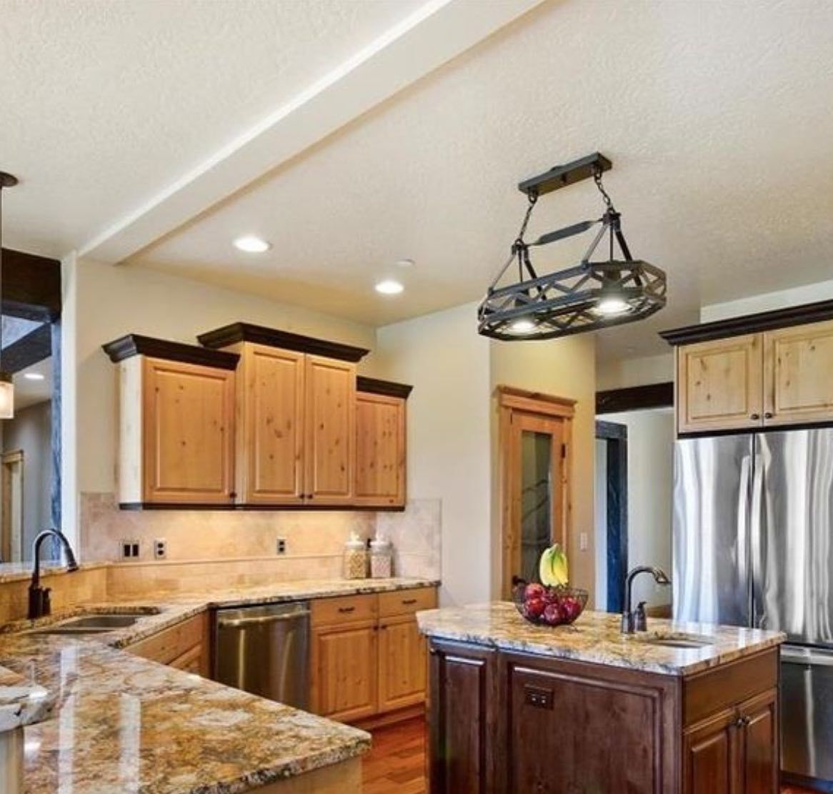 A kitchen with wooden cabinets and granite counter tops