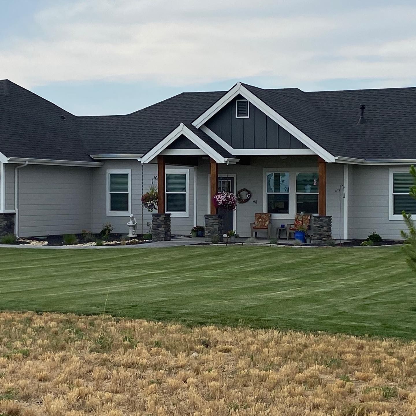 A large house with a large lawn in front of it.