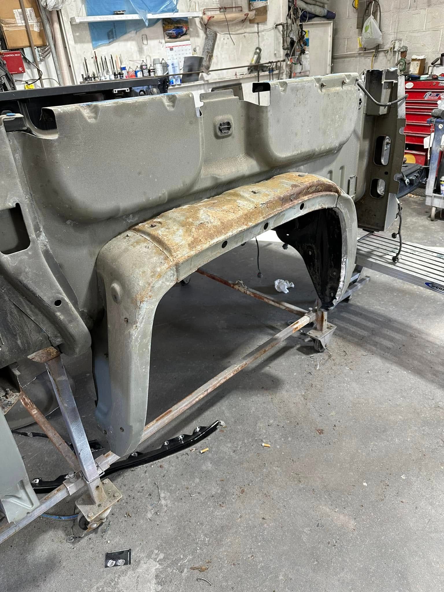 A piece of metal is sitting on the ground in a garage.