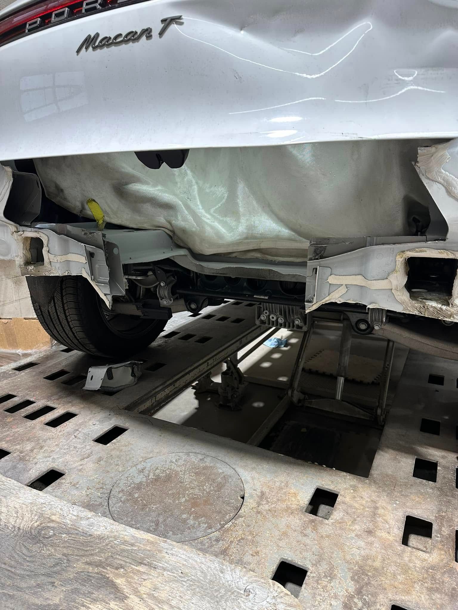 A white car is being towed by a tow truck.