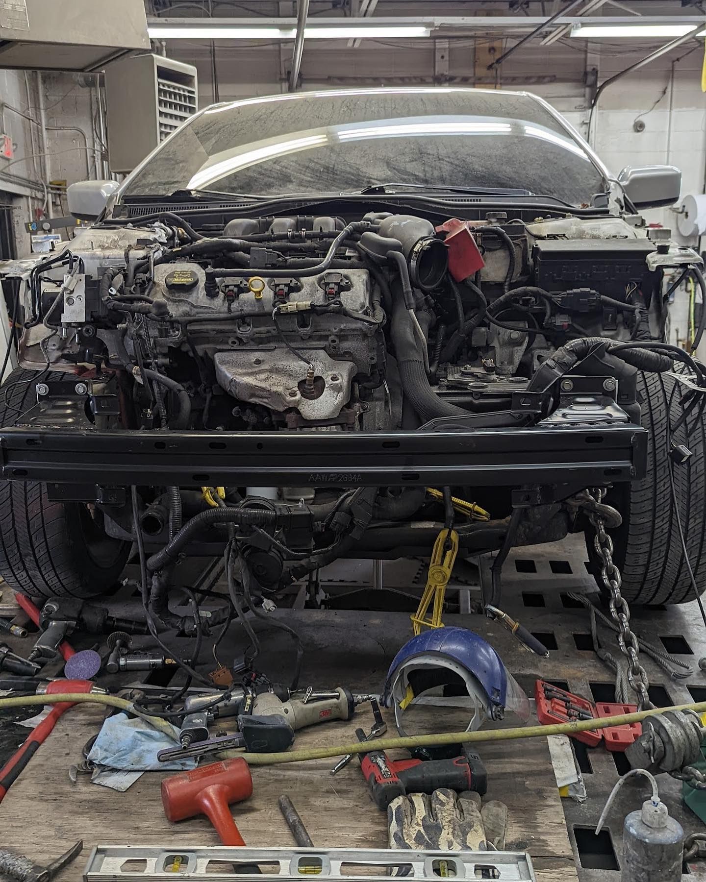 A car is being worked on in a garage.