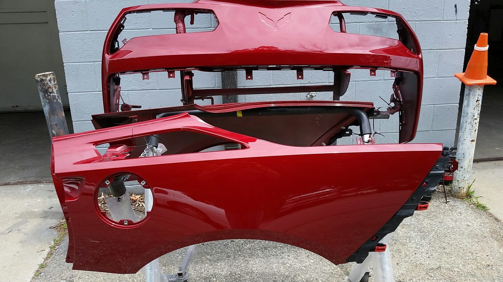 Pieces of a red car are sitting on a table