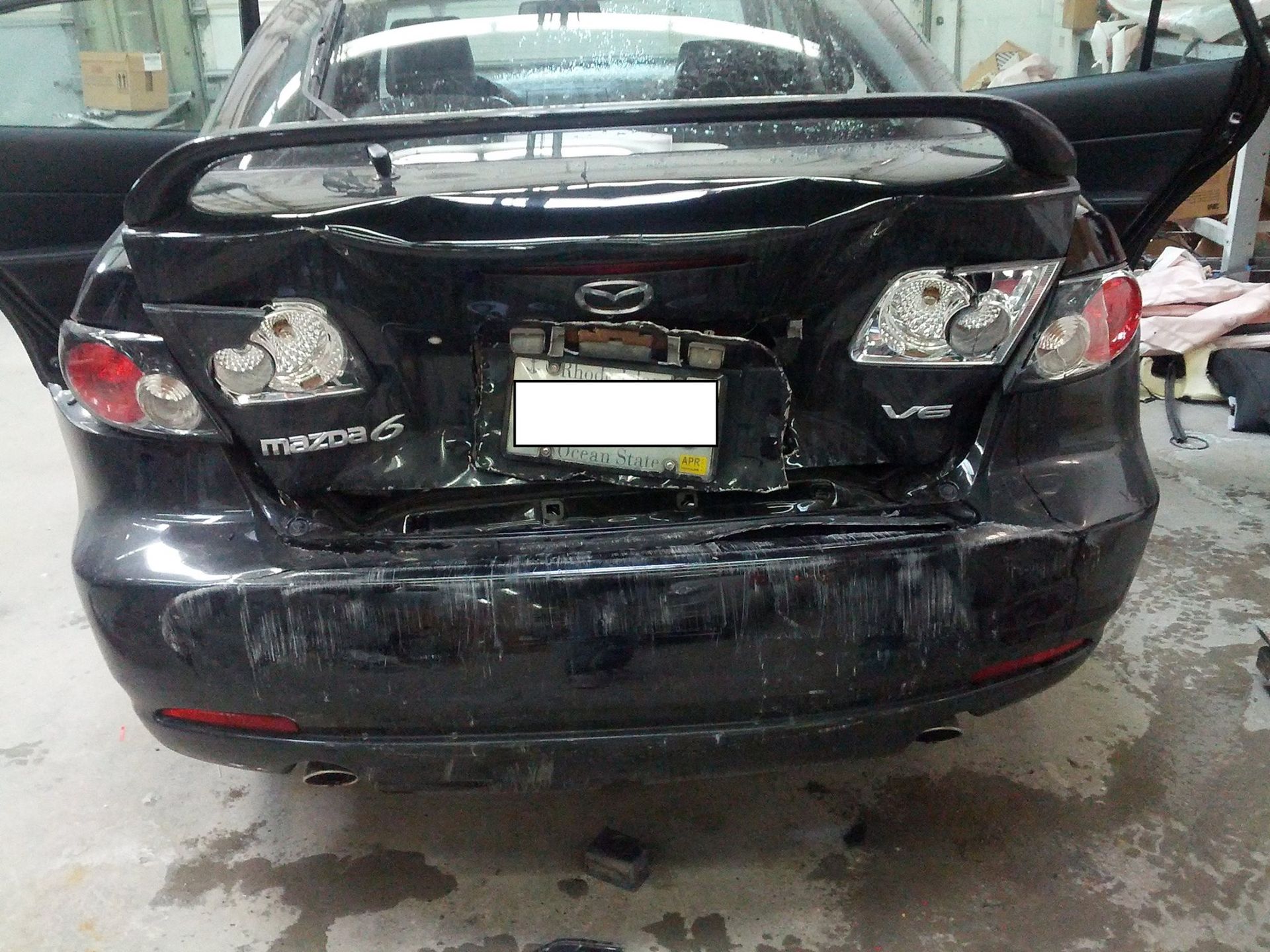 A black car with a license plate that says mazda