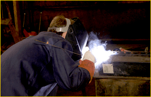 Man welding small piece of metal