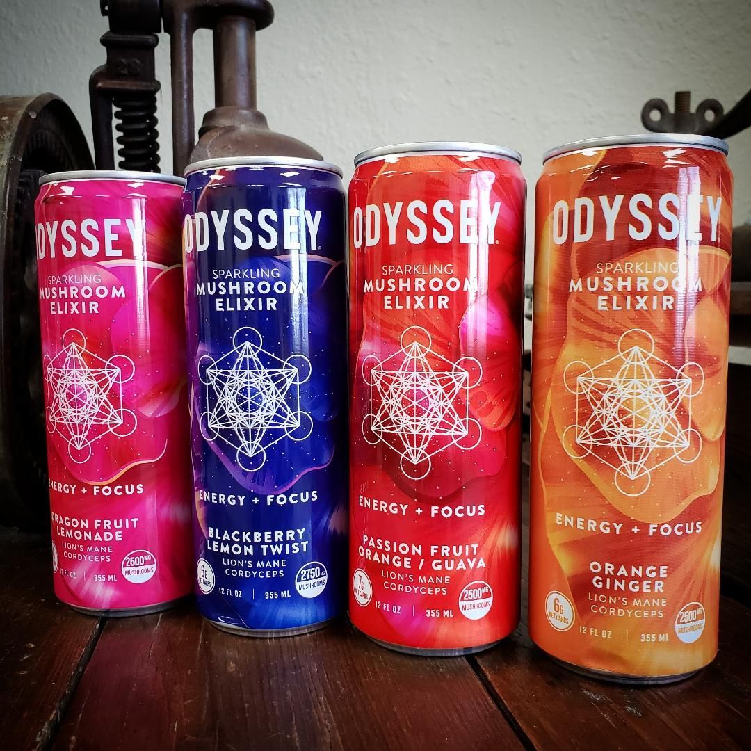 Four cans of Odyssey mushroom elixir in pink, blue, red, and orange, labeled with flavors and energy-focus benefit.
