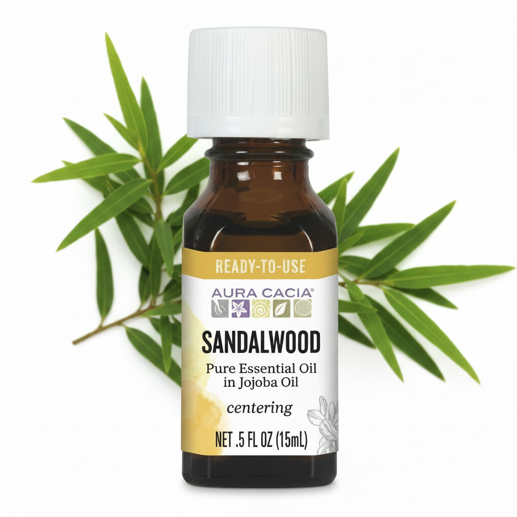 Brown amber essential oil bottle labeled sandalwood with green leaves behind it