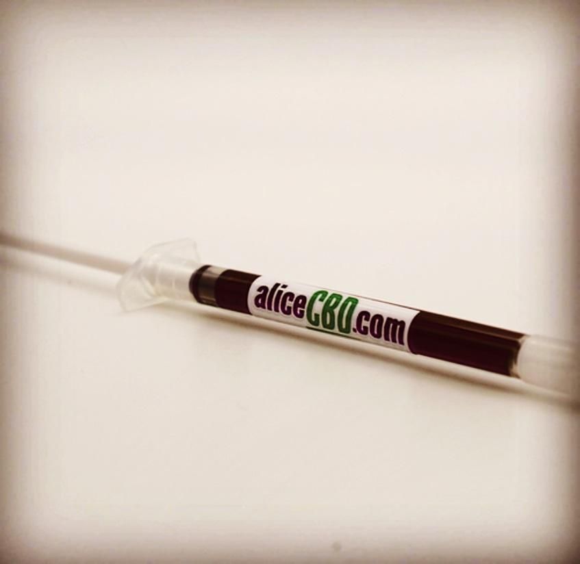 Syringe of dark liquid with 