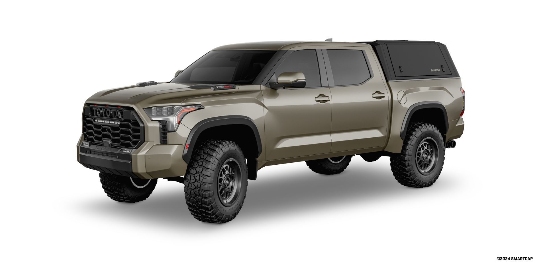 Tan Toyota Tundra pickup truck with black canopy on a white background.