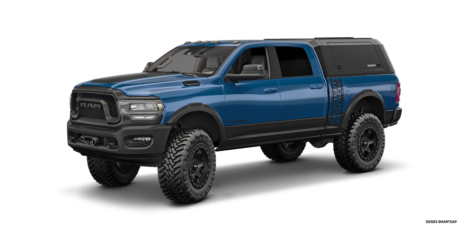 Blue Ram pickup truck with black wheels and camper shell.