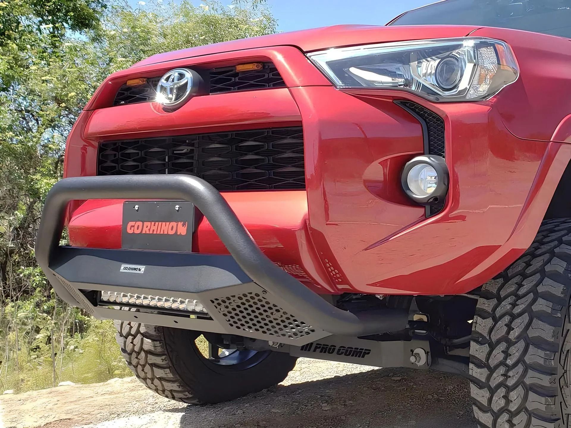 Red Toyota 4Runner with black bull bar and LED light bar.