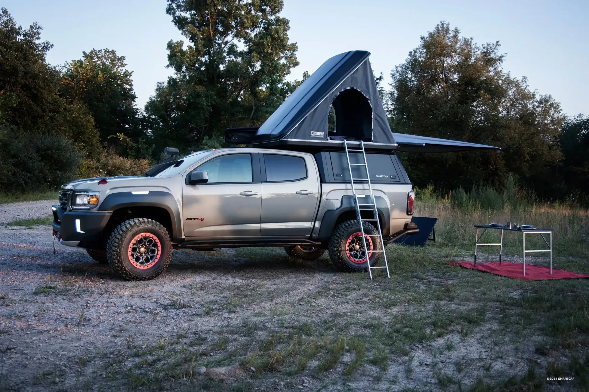 Red Dodge pickup truck with a silver camper shell.