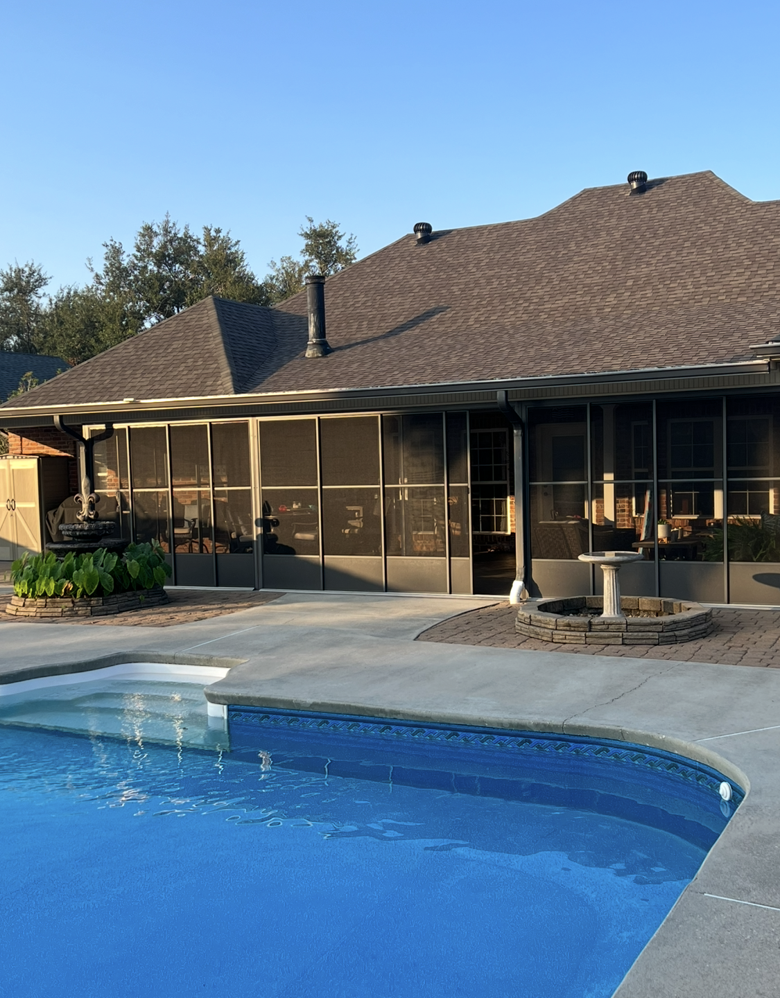 A house with a swimming pool in front of it.