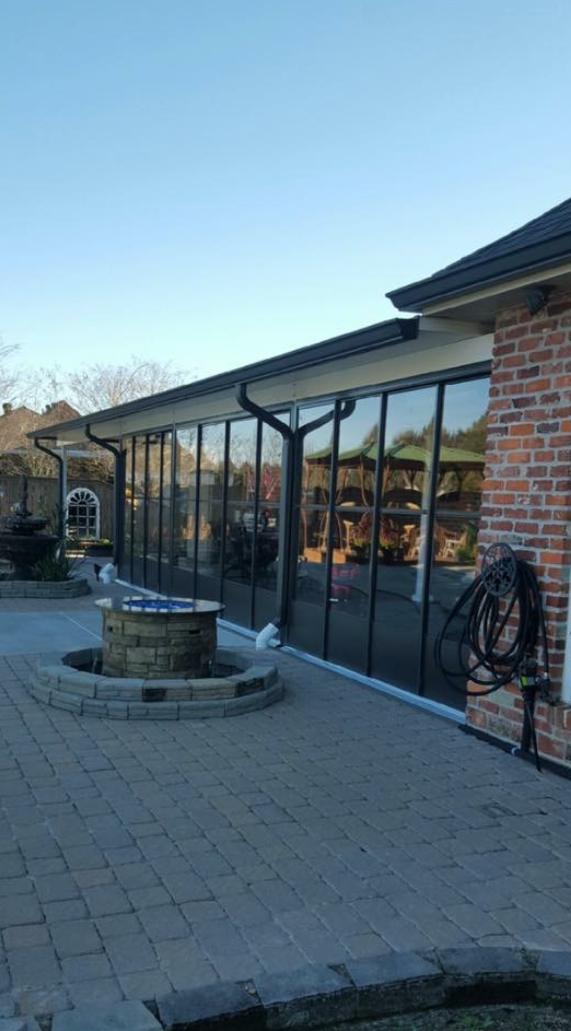 A large building with a lot of windows and a fire pit in front of it.