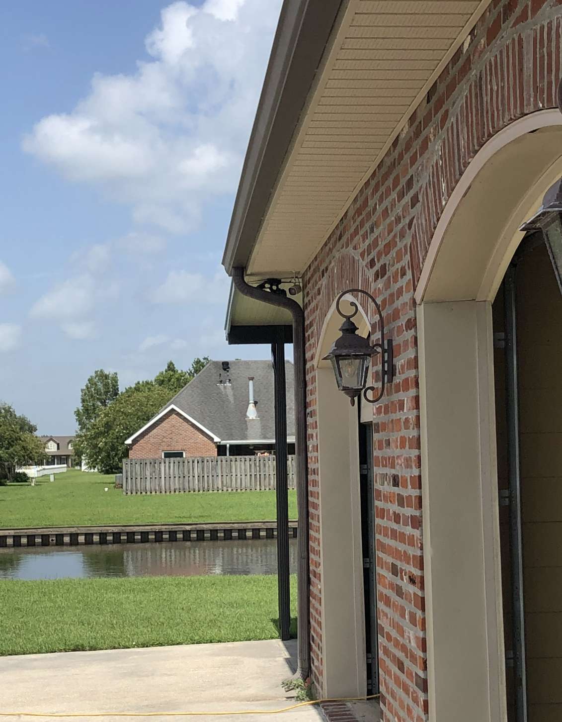 A brick building with a light on the side of it.