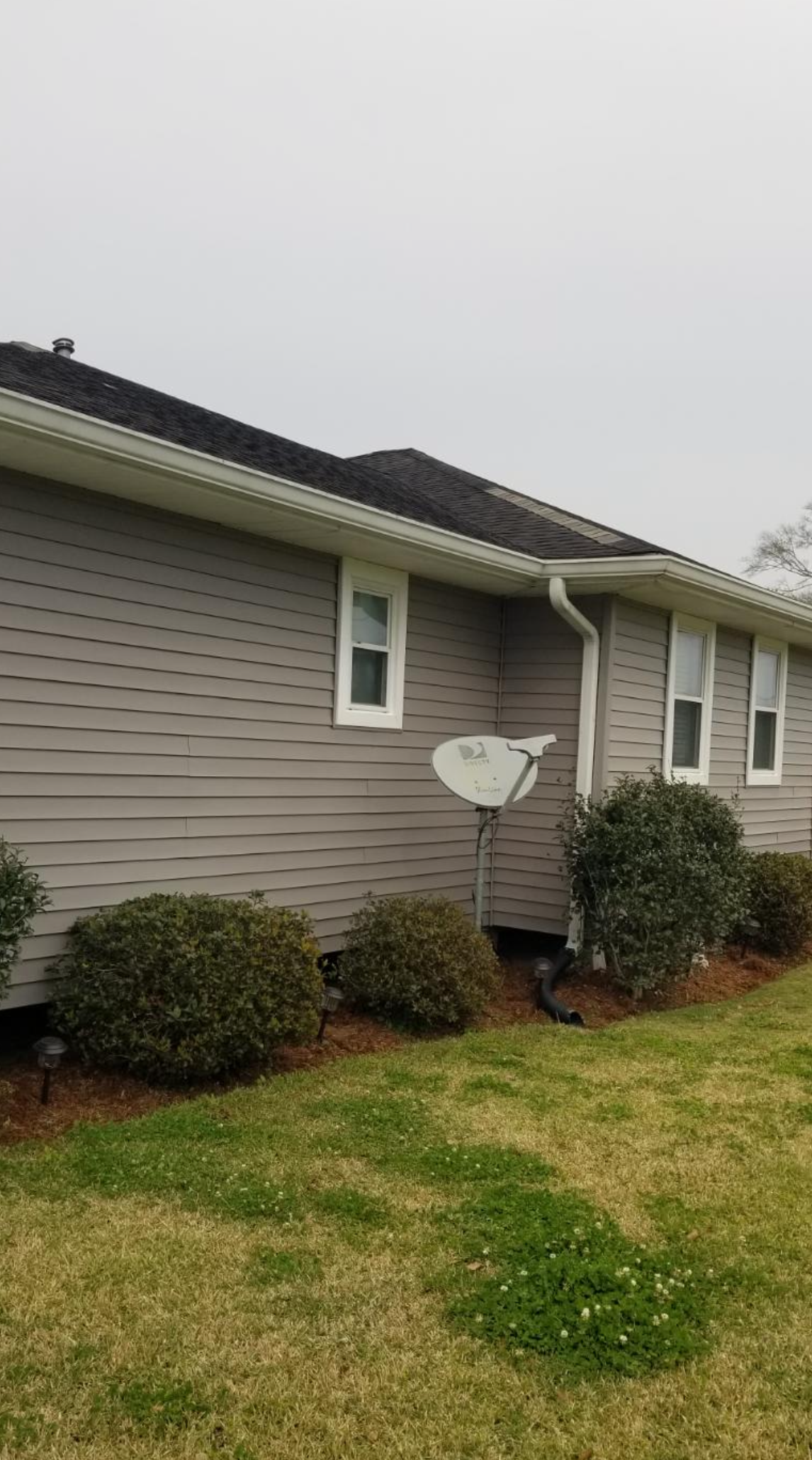 A house with a satellite dish on the side of it.