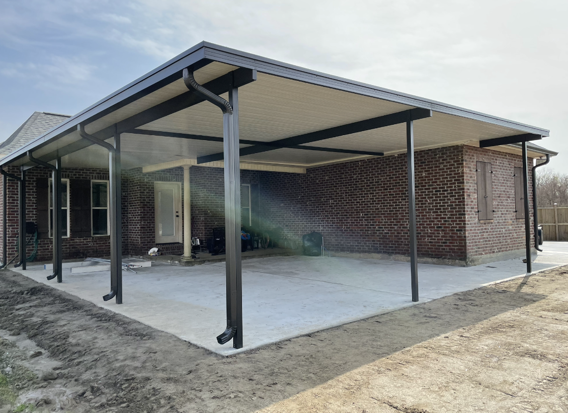There is a carport in the backyard of a house.