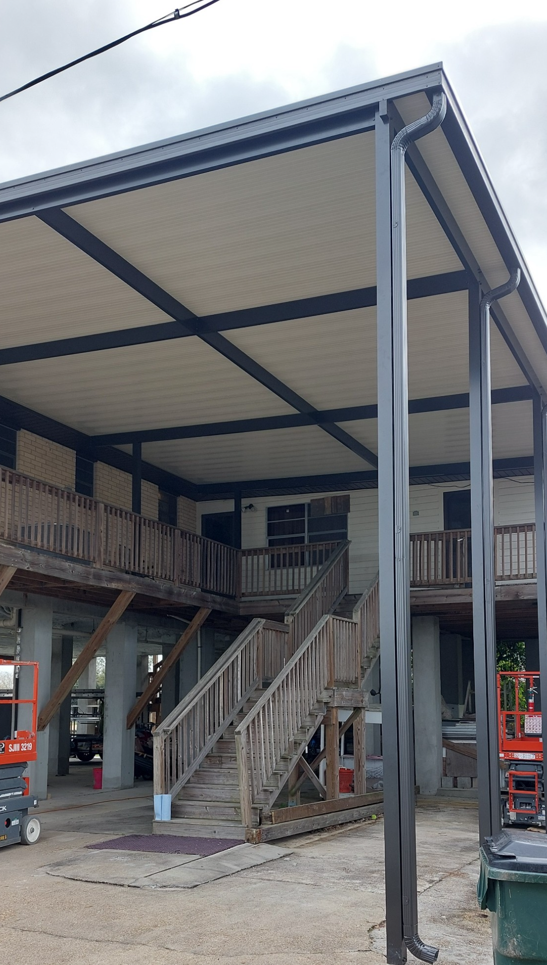 A house with a covered porch and stairs under construction.