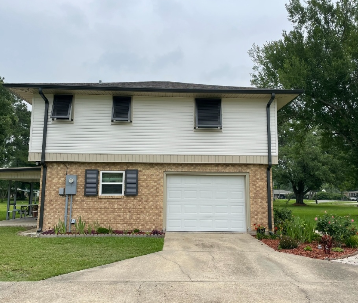 The front of a house with a garage and a driveway.