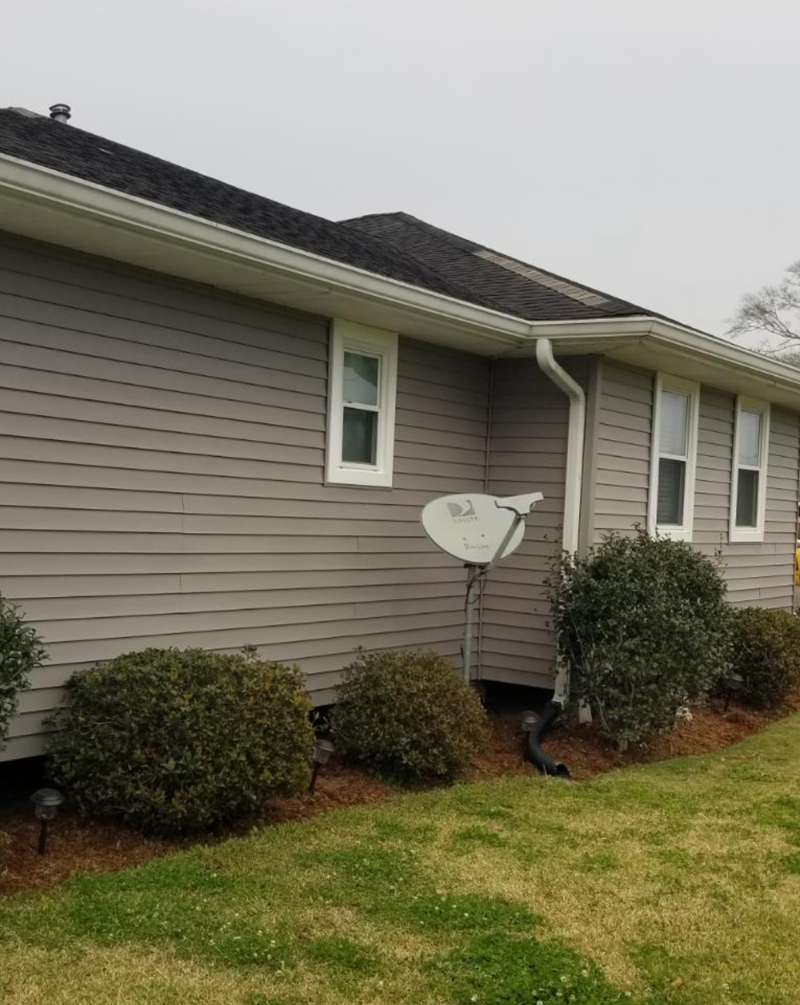 A house with a satellite dish on the side of it.