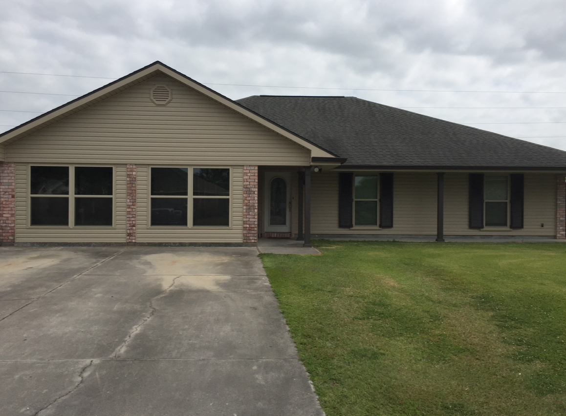 A large house with a lot of windows and shutters.