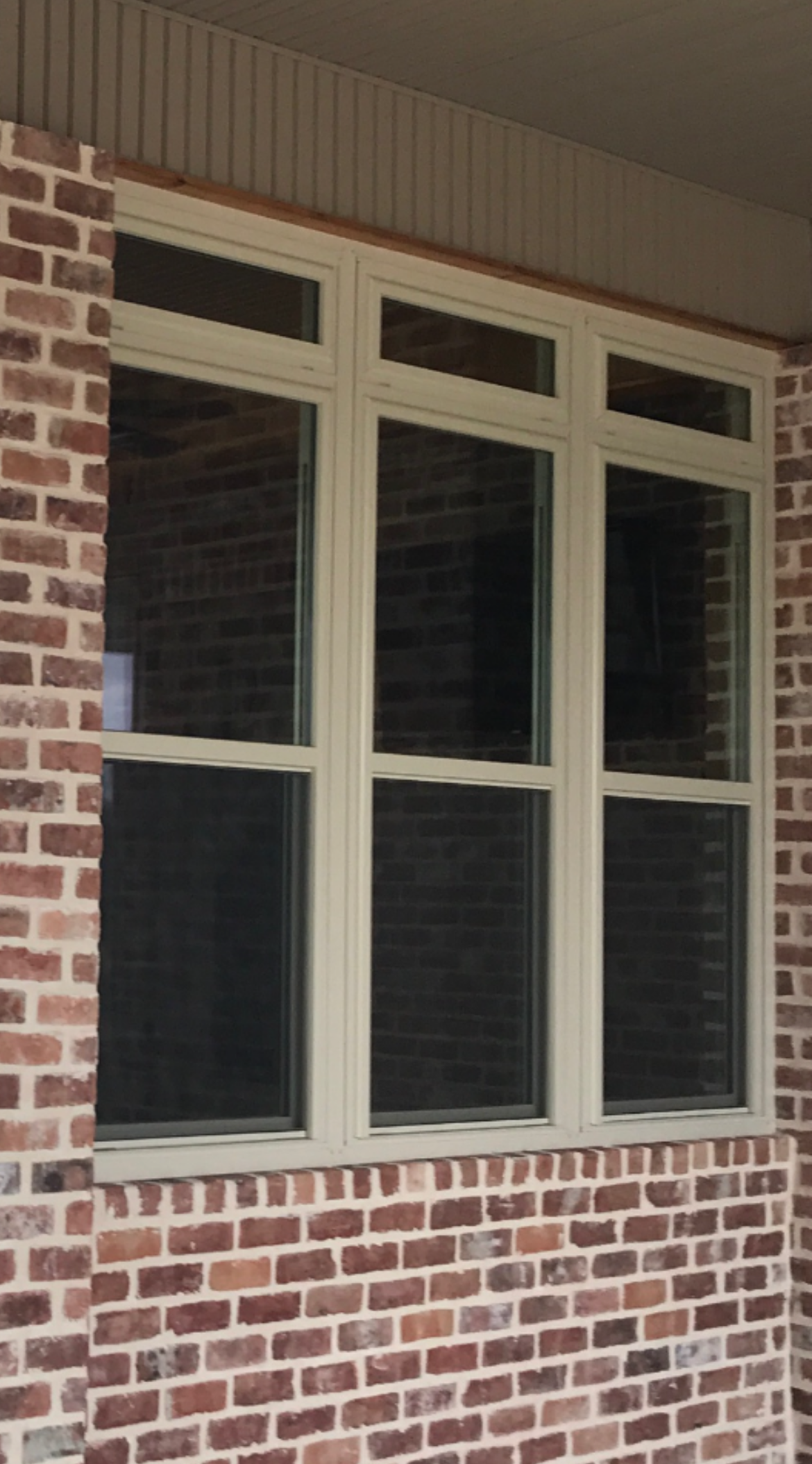 A house with a blue door and a window on the side.