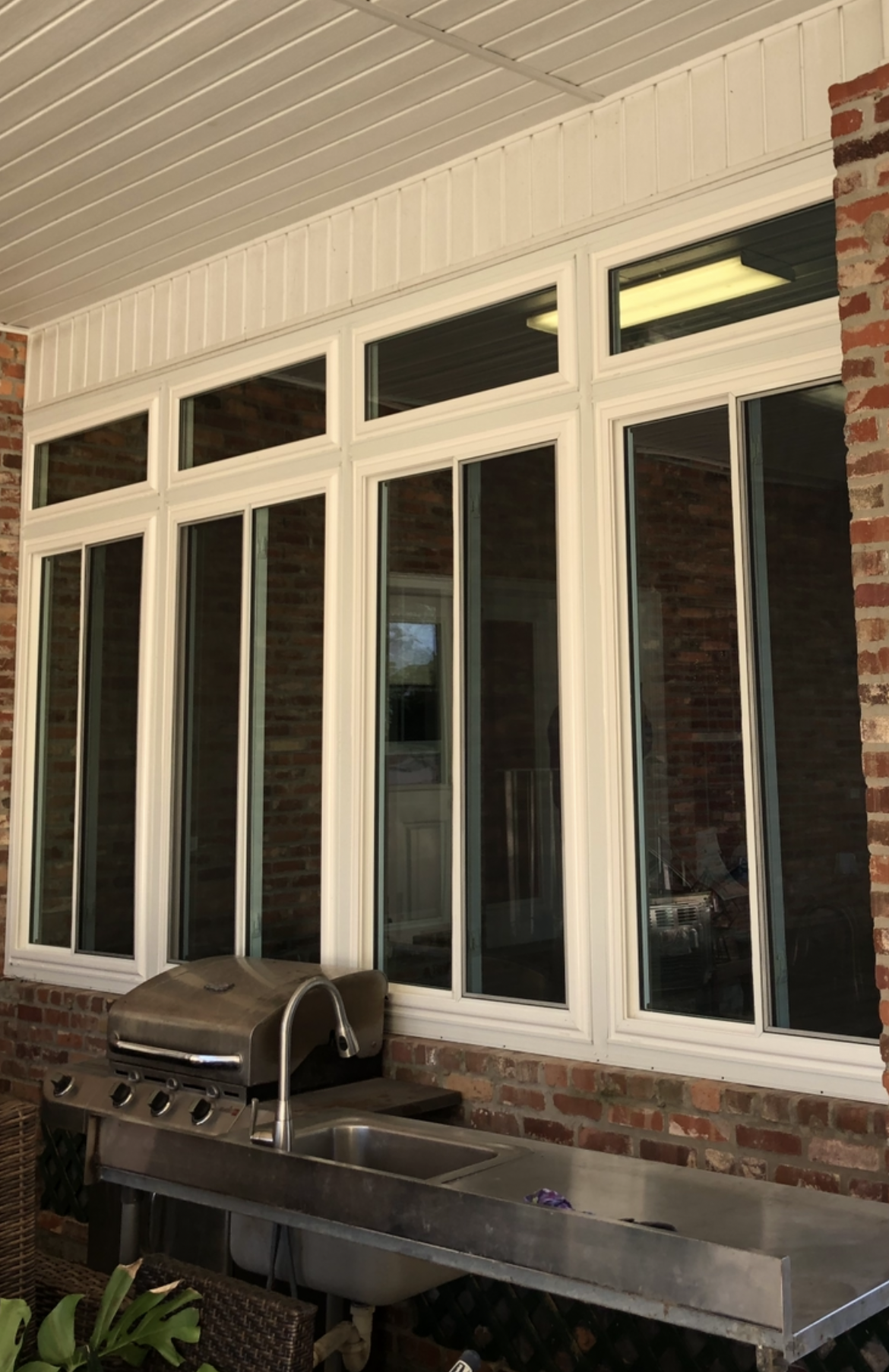 A large window on the side of a brick building.