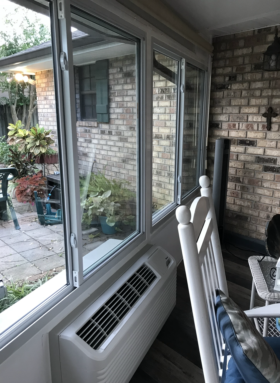 A white building with a lot of windows and a pool in the background.