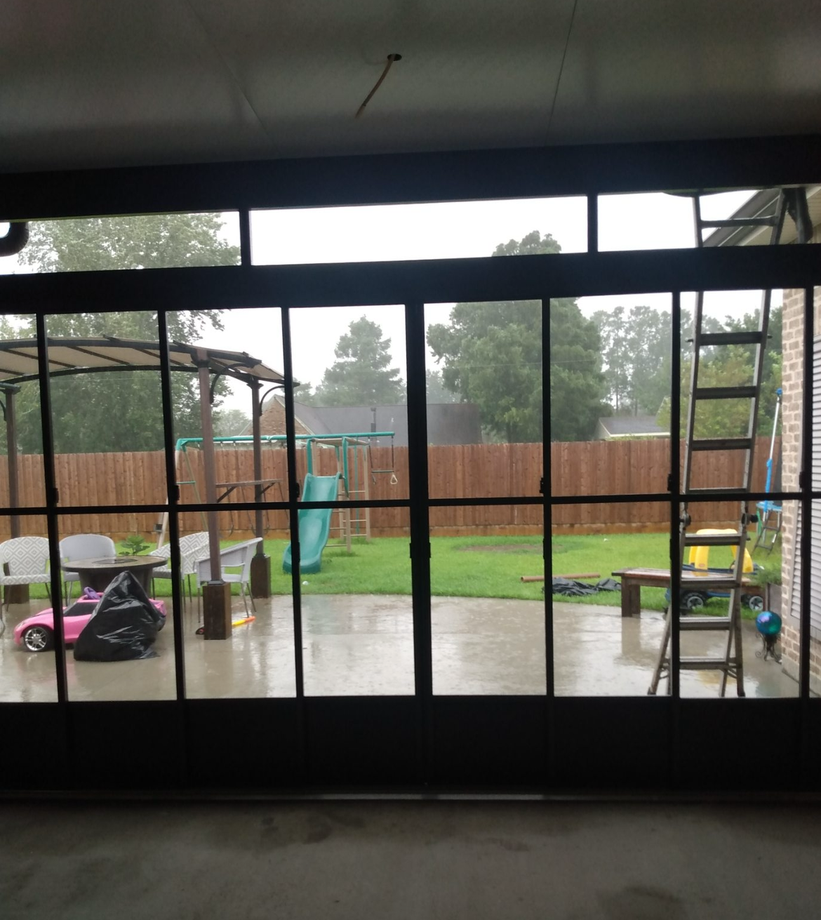 A view of a backyard through a sliding glass door.