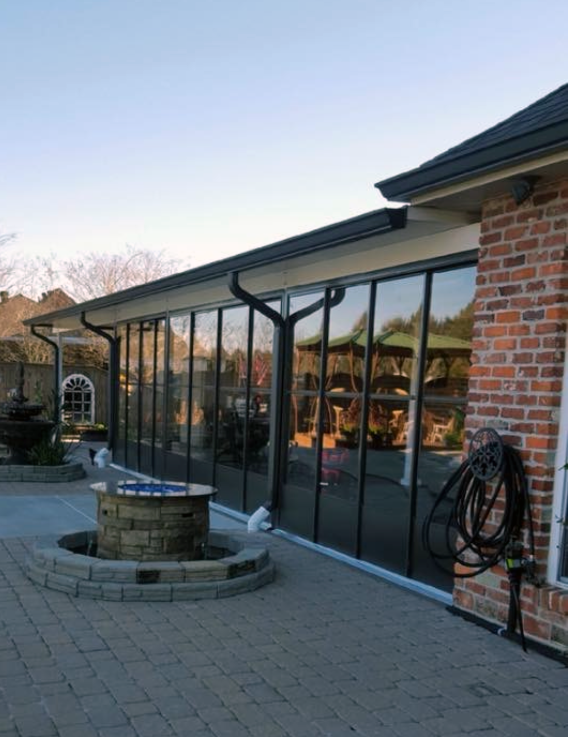 A brick building with a fountain in front of it.