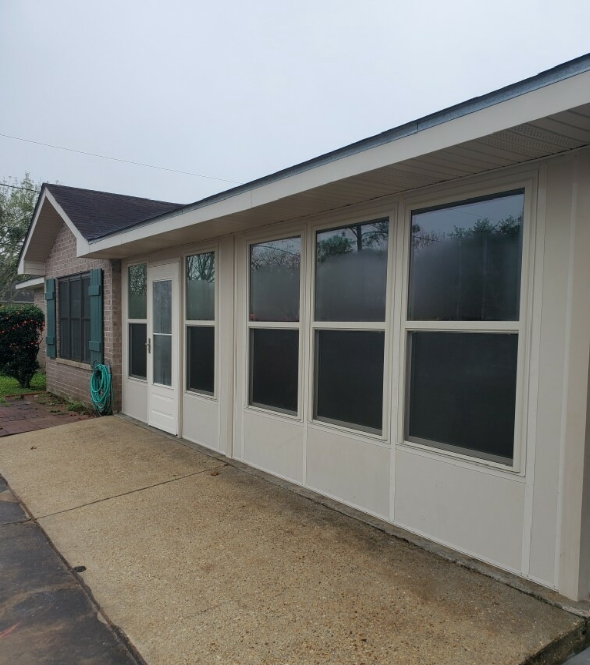 A white house with a lot of windows and doors.