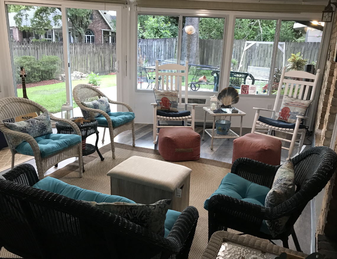 A living room filled with furniture and a sliding glass door.