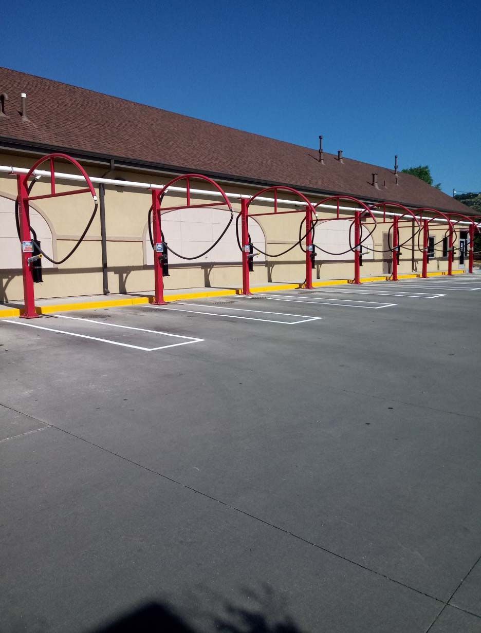 A row of cars are being washed at a car wash