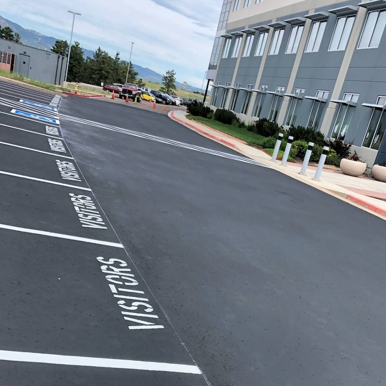 A parking lot with the word visitors painted on it