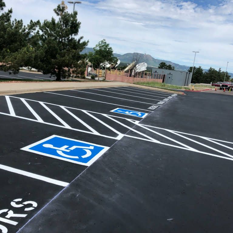 A parking lot with a handicap sign painted on it