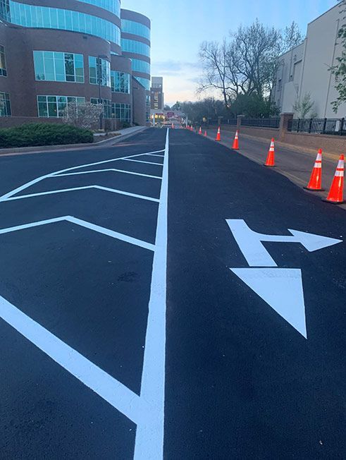 An arrow is painted on the side of a road