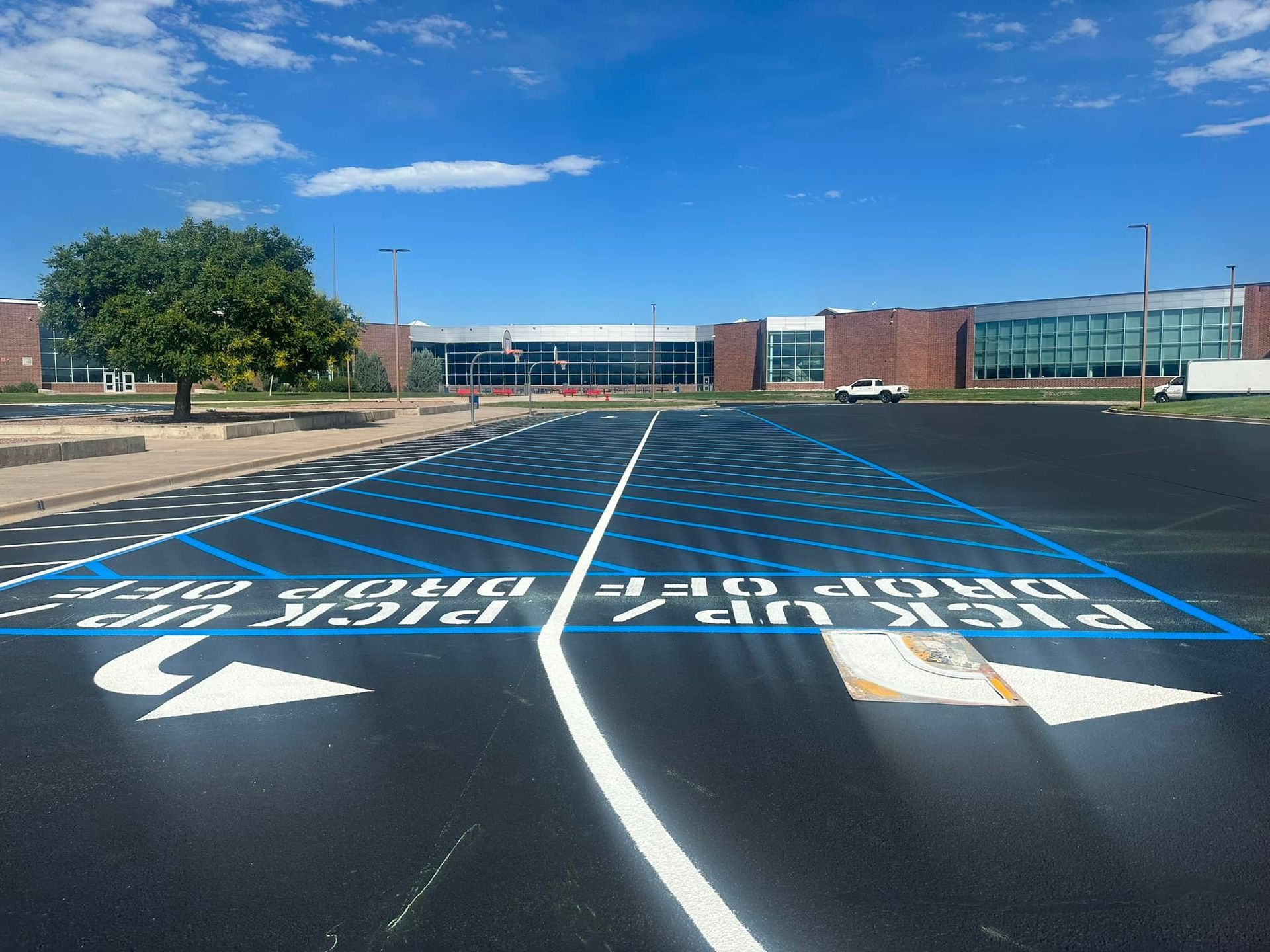 A parking lot with a sign that says pick up and drop off