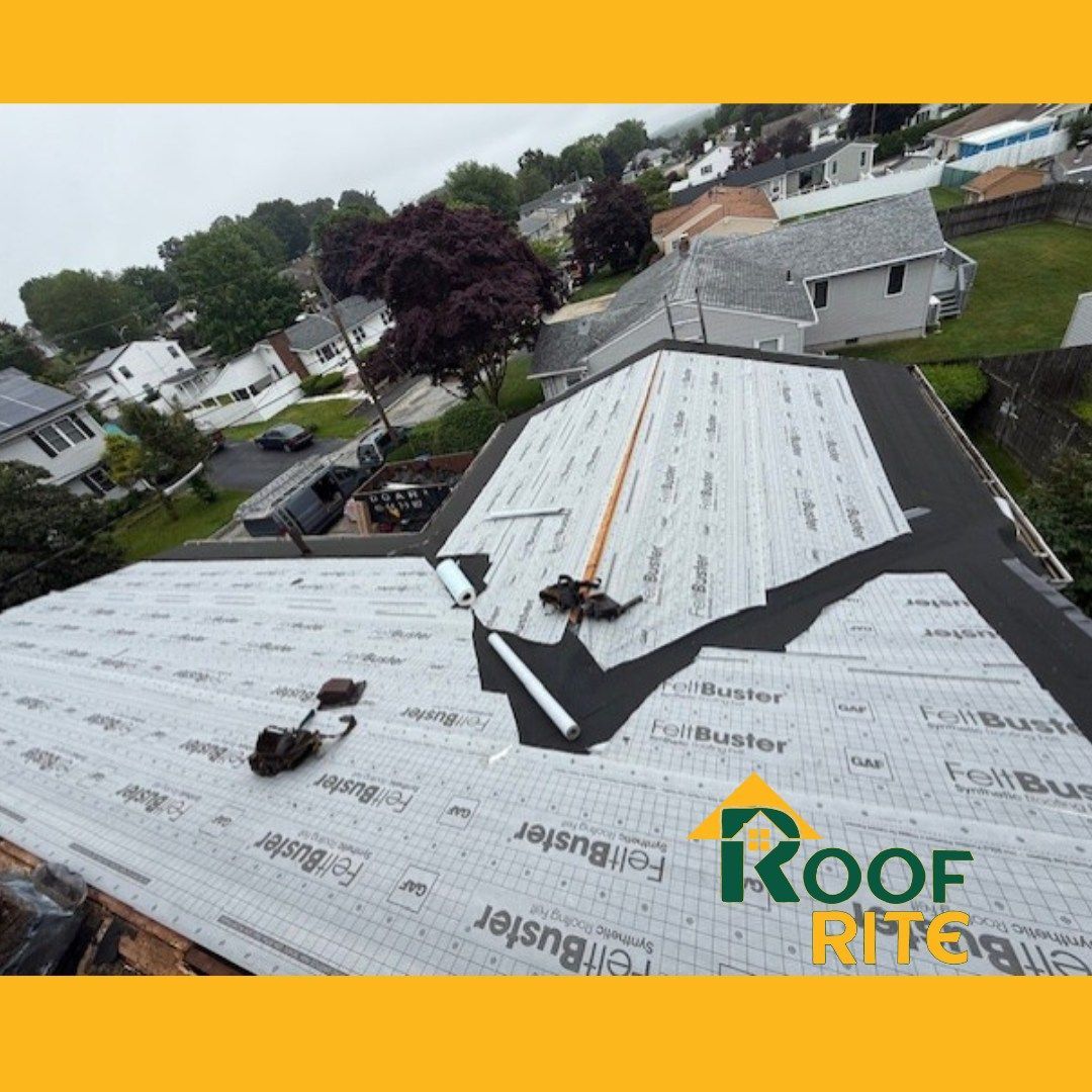 Rooftop with new roofing materials being installed; includes logo of roofing company.