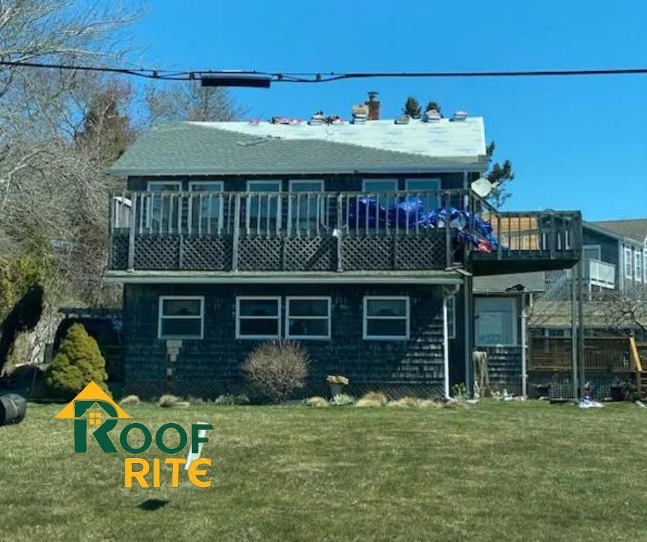 Two-story house with workers on the roof