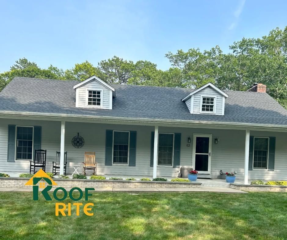 Single-story gray house with white trim and dormer windows, front porch