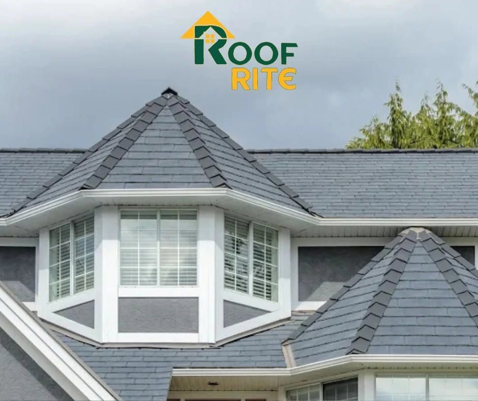 A gray shingled house roof with white dormer windows