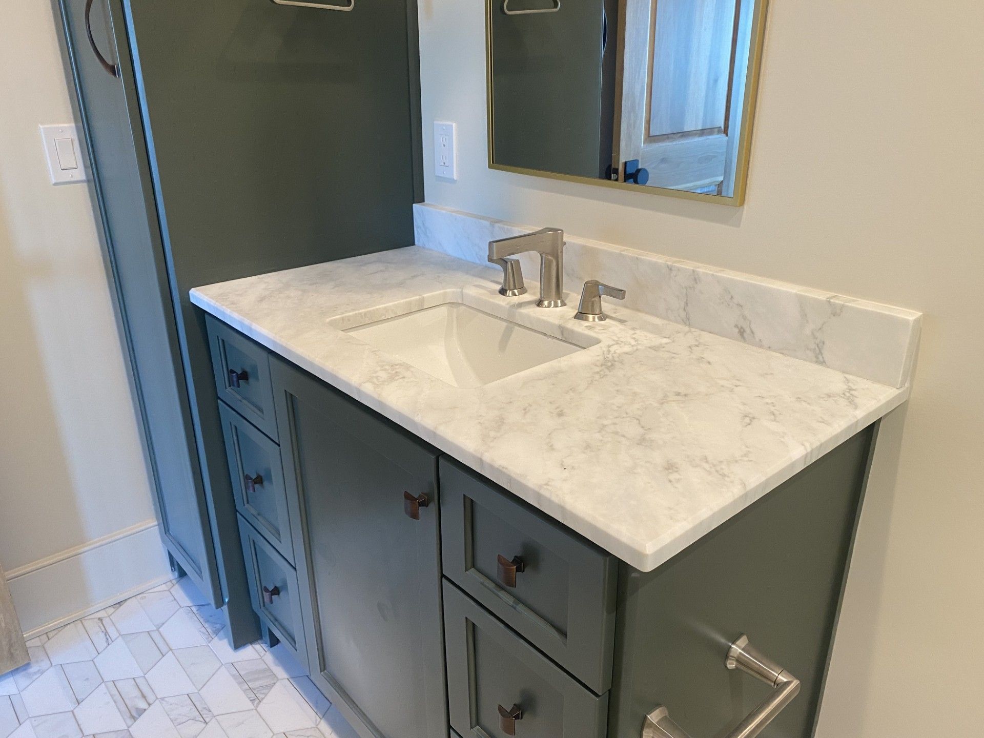 A bathroom vanity with a sink and a mirror.