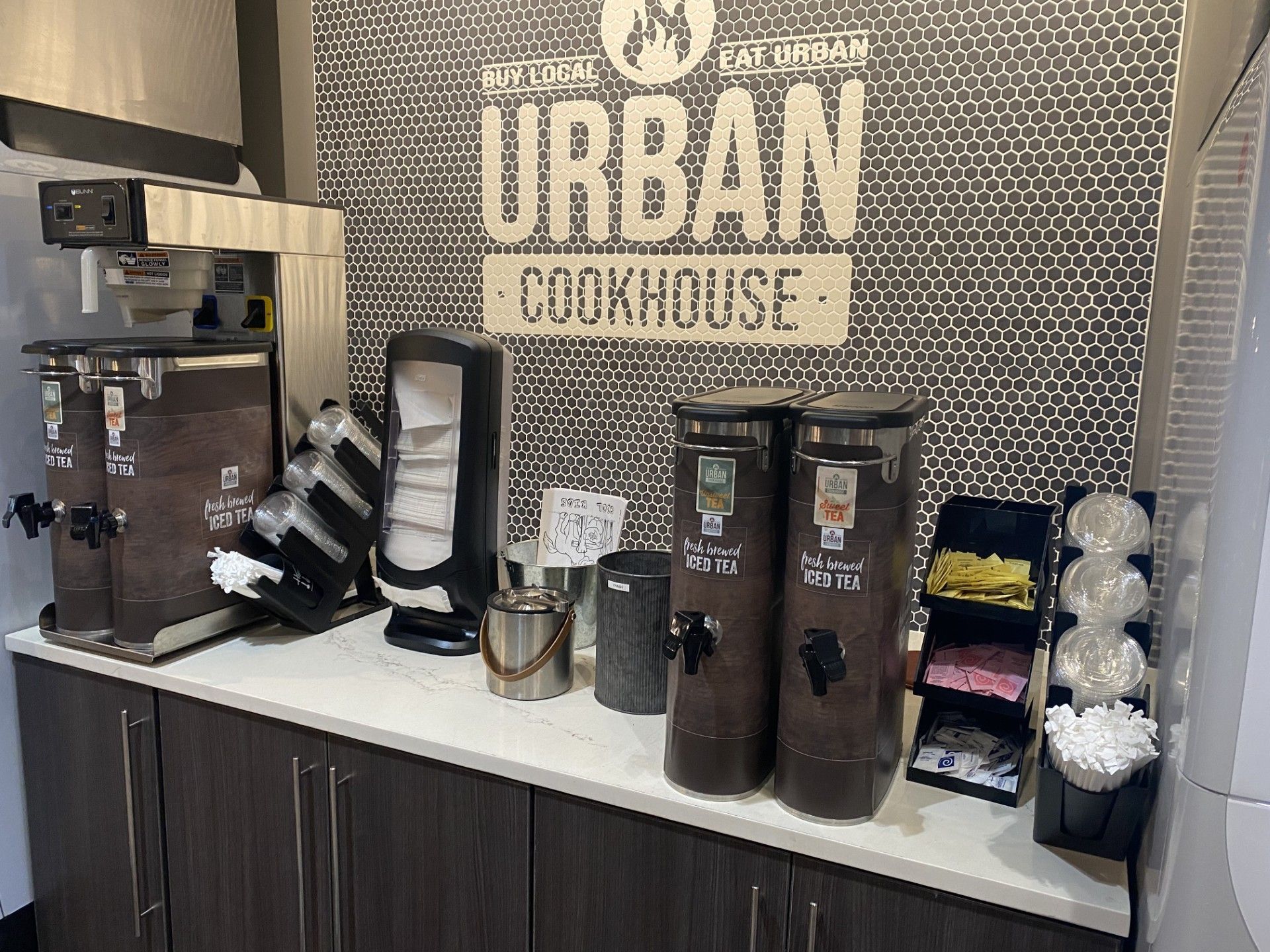 A kitchen with a sign on the wall that says `` urban cookhouse ''.