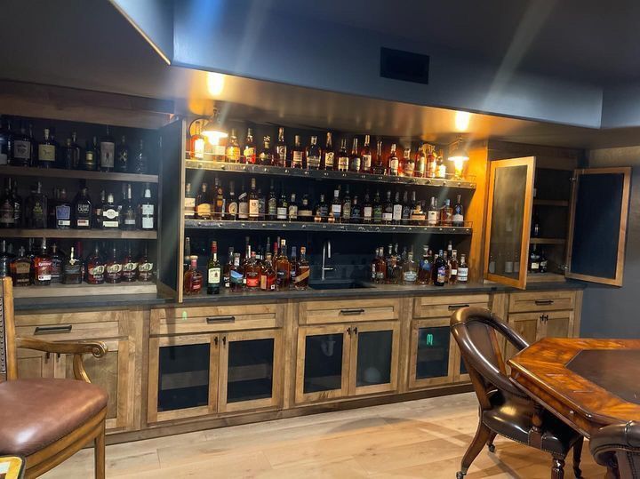 A room with a lot of bottles of alcohol on shelves